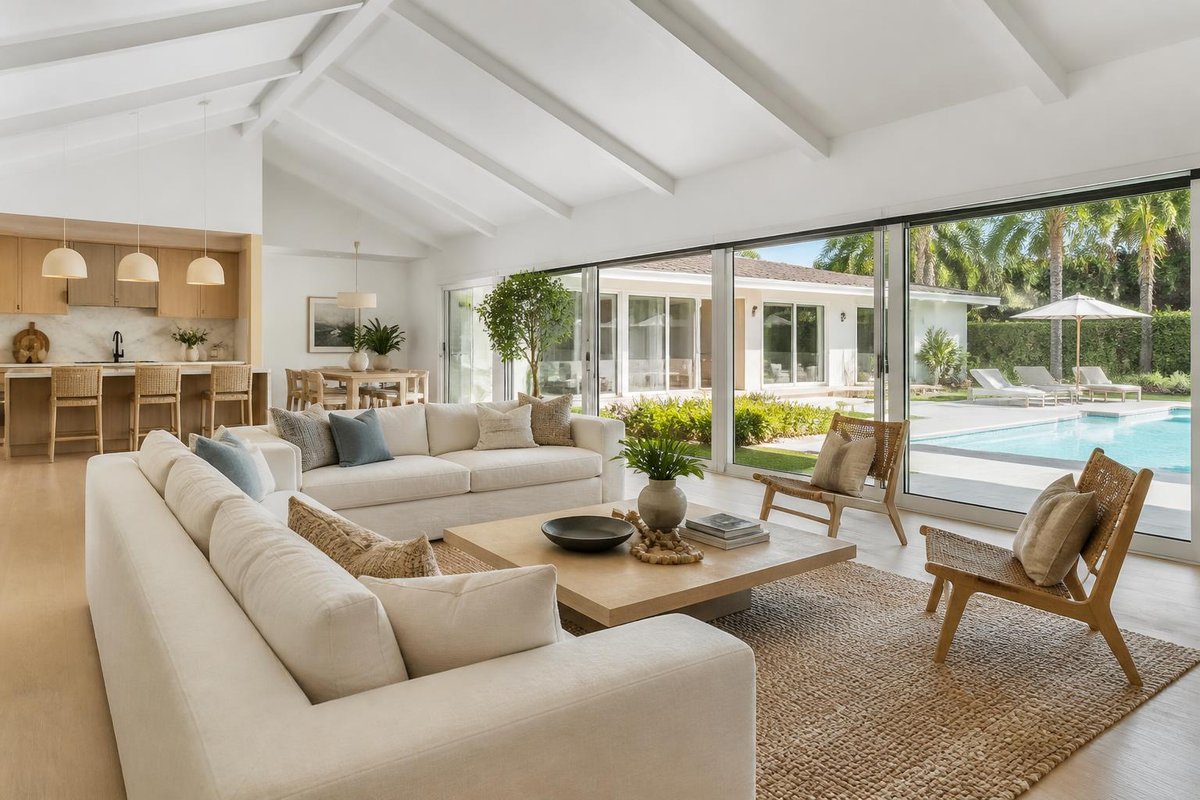 Living room with vaulted ceiling open to the pool